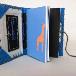 BlueBlack, (inside) 2016, 6.25 x 10 x 5", board, felt, paper, metal, hemp cord